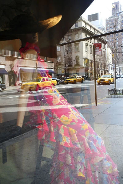 USA, New York, New York City, Manhattan, yellow taxi cabs reflected in a fashionable