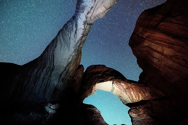 USA, Utah, Double Arches rock formations illuminated by night in the Arches National Park