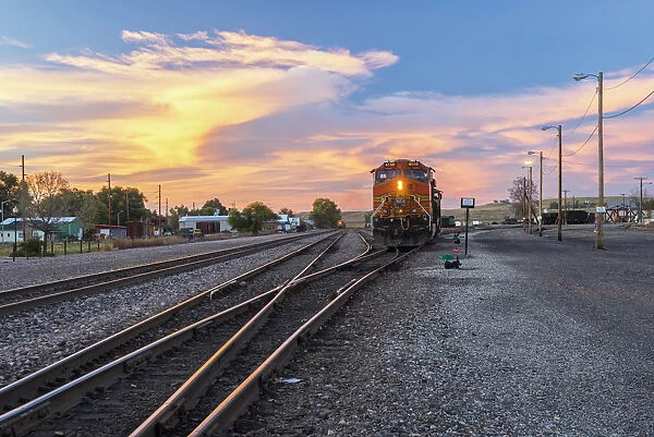 USA, Whyoming, Sheridan, Coal train in the town of Sheridan at dusk