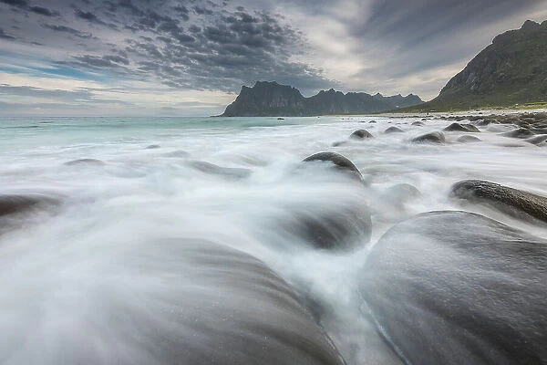 Uttakleiv beach during a windy summer morning, with some breaking waves in the foreground. Lofoten Islands, Norway