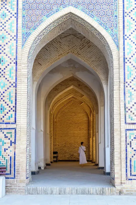 Framed Print : Uzbekistan, Bukhara, Po-i-Kalyan, Kalon Mosque, a tourist walks through an arched walkway