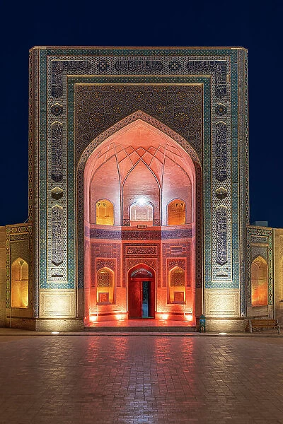 Uzbekistan, Bukhara, Po-i-Kalyan, Kalon Mosque main entrance illuminated at sunset