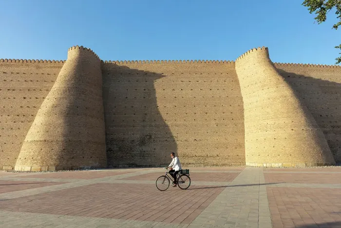 Framed Print : Uzbekistan, Bukhara, UNESCO world heritage site, Ark Fortress, a man cycles past the city walls Framed Print : Uzbekistan, Bukhara, UNESCO world heritage site, Ark Fortress, a man cycles past the city walls