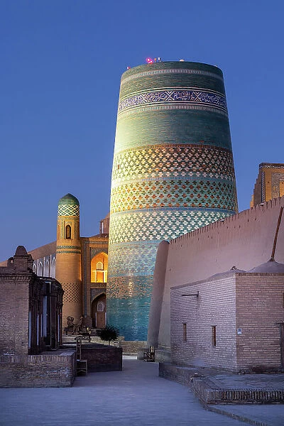 Uzbekistan, Khiva, the Khuna Ark citadel and the Kalta Minor minaret illuminated at sunrise