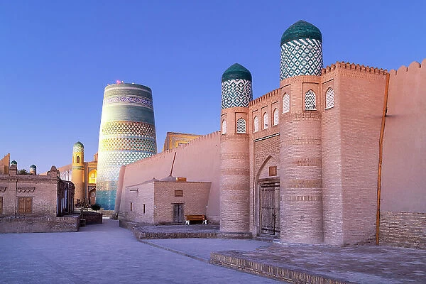 Uzbekistan, Khiva, the Khuna Ark citadel and the Kalta Minor minaret illuminated at sunrise
