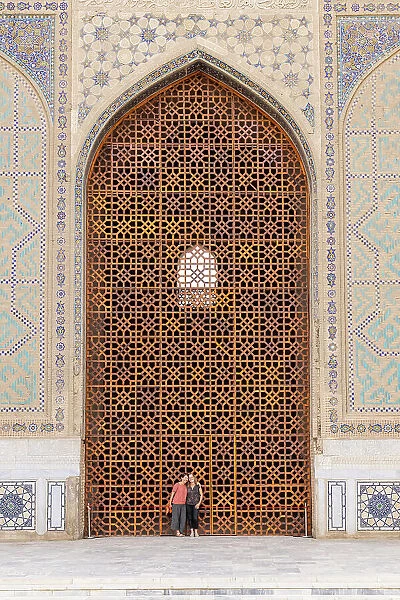 Uzbekistan, Samarkand, Bibi-khanym mosque, two women stand in the huge doorway