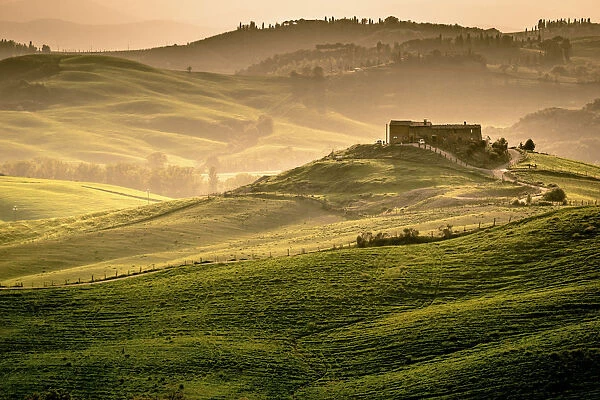 Val d Orcia, Tuscany, Italy. A lonely farmhouse with cypress and olive trees