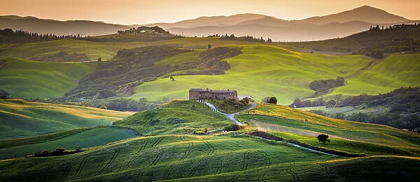 Val d Orcia, Tuscany, Italy. A lonely farmhouse with cypress and olive trees