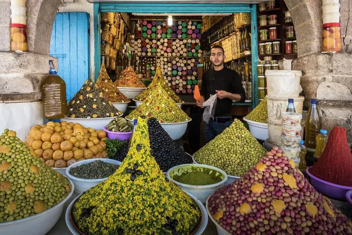 Framed Print : Vendor in olive and spice shop in market in the medina (old city), Essaouira, Morocco Framed Print : Vendor in olive and spice shop in market in the medina (old city), Essaouira, Morocco