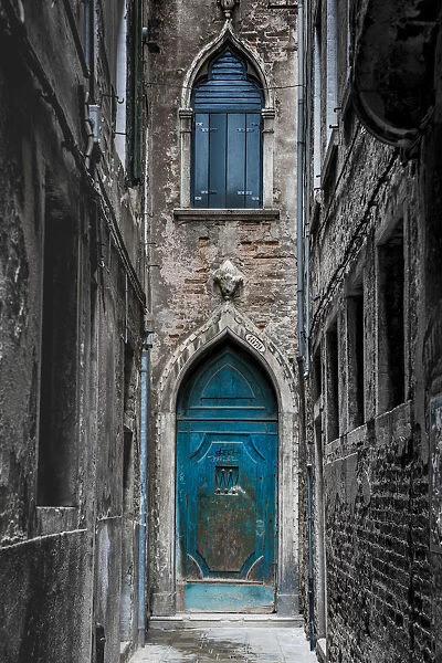 Venice, Veneto, Italy. Blue moorish door in a narrow street