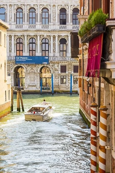 Venice, Veneto, Italy. Buildings and boats in the canals. Ca Pesaro Palace