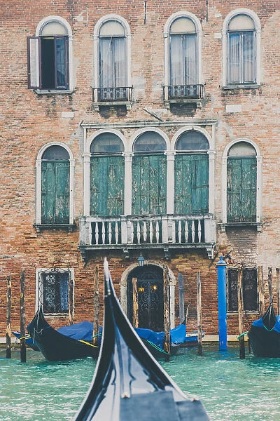 Venice, Veneto, Italy. Gondolas and waterfront palace