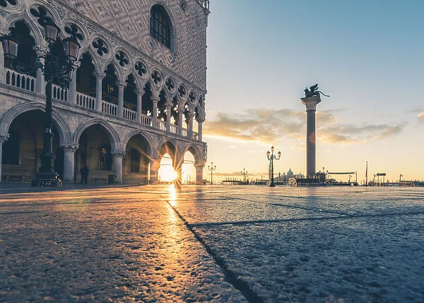 Venice, Veneto, Italy. Sunrise through the arches of Doges Palace in Piazzetta San Marco