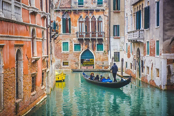 Venice Veneto, Italy. Tourists on gondola and waterfront palaces