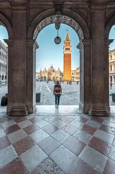 Venice, Veneto, Italy. Woman tourist looking at St Marks Square