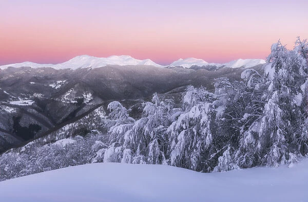 Venus belt surrounds the Appenines mountain range during a cold winter sunrise in Tuscany