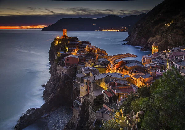 Vernazza, Liguria, Italy. View of the village during sunset, with trees on the foreground