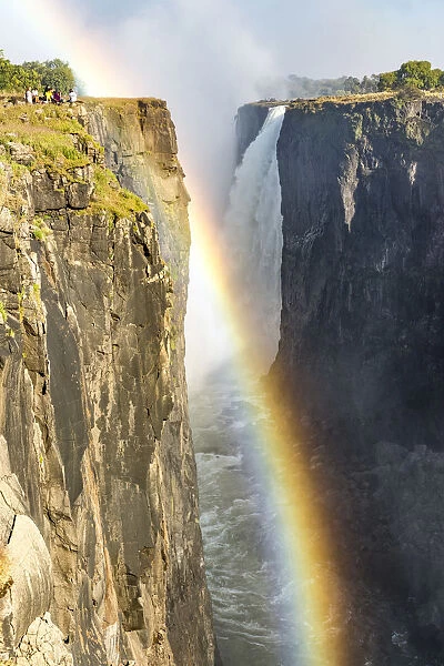 Victoria Falls, Zimbabwe, Africa. Rainbow and water steam