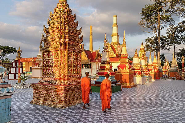 Vietnam, Bac Lieu Province, Bac Lieu, Chua Xiem Can, Khmer pagoda, two novice monks walk through the pagoda complex