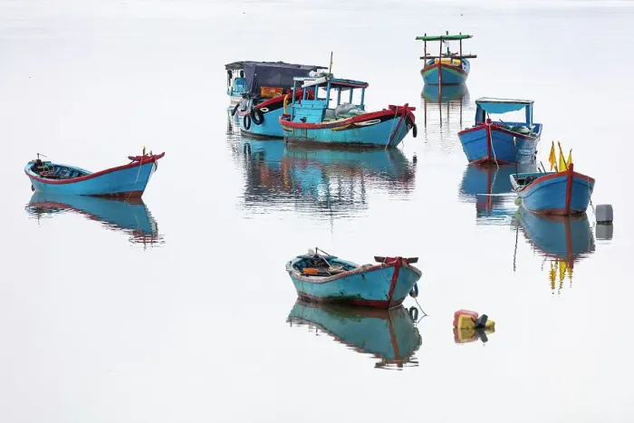 Framed Print : Vietnam, Cam Ranh, traditional fishing boats reflected in calm water Framed Print : Vietnam, Cam Ranh, traditional fishing boats reflected in calm water