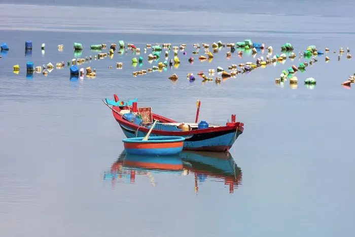 Framed Print : Vietnam, Phu Yen, a blue fishing boat and basket boat Framed Print : Vietnam, Phu Yen, a blue fishing boat and basket boat