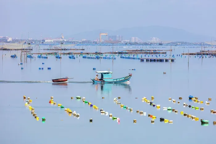 Framed Print : Vietnam, Phu Yen, a fishing boat pulls a basket boat in a lagoon Framed Print : Vietnam, Phu Yen, a fishing boat pulls a basket boat in a lagoon