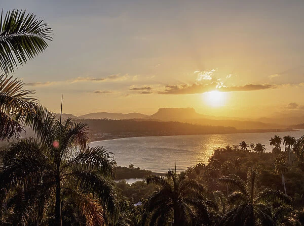 View over Bahia de Miel towards city and El Yunque Mountain, sunset, Baracoa