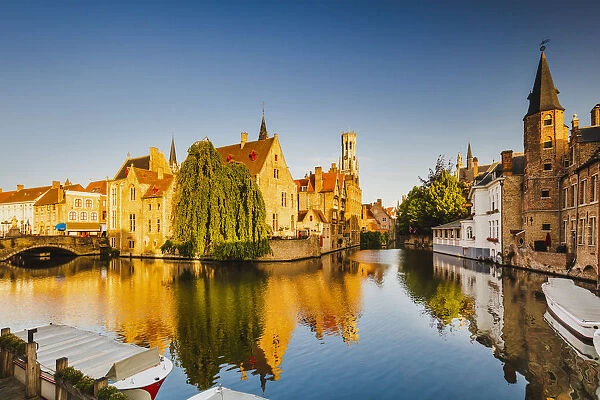 View of Bruges old town reflecting in the water canal at sunrise, Belgium