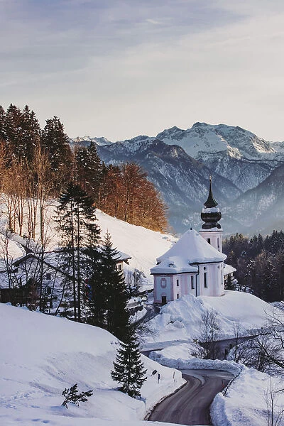 View of the church of Wallfahrtskirche Maria Gerna at sunset in winter sorrounded