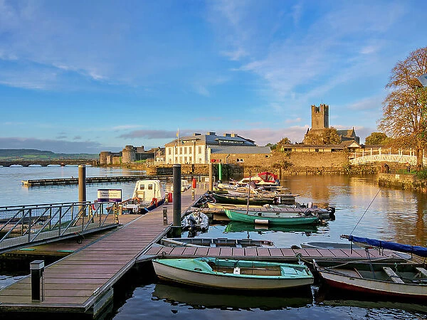 View over city marina towards King John's Castle and Saint Mary's Cathedral at sunset, Limerick, County Limerick, Ireland