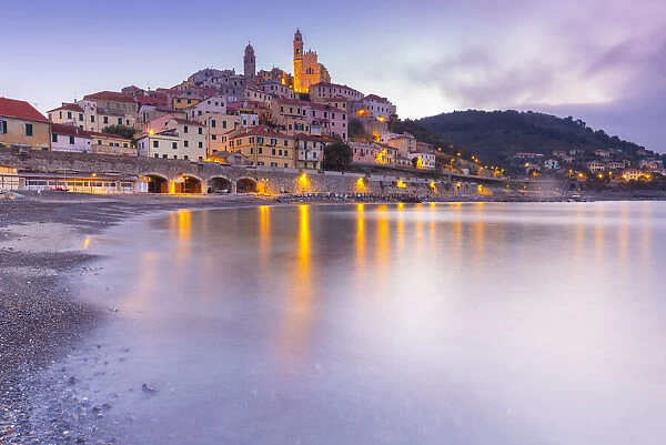 View of the colorful town and beach of Cervo at sunrise