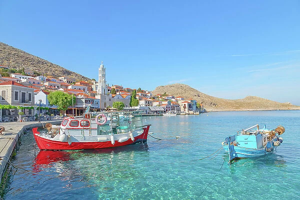 View of Emporio harbour and Saint Nicholas church in the distance, Halki Island, Dodecanese Islands, Greece