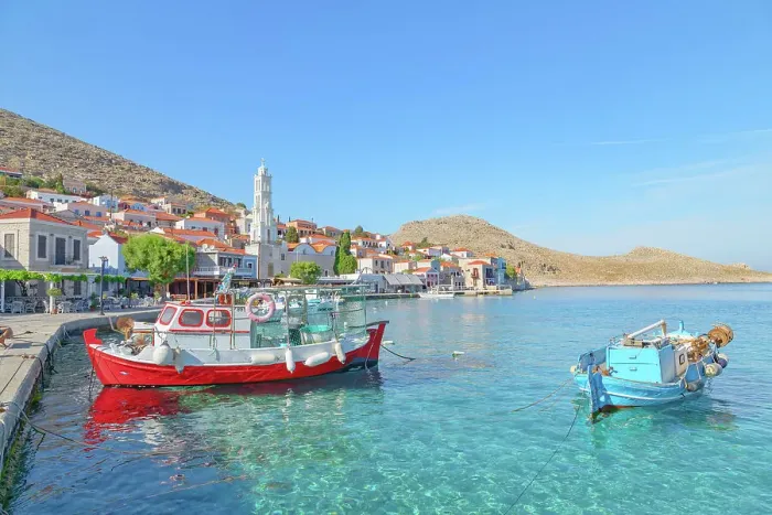 Framed Print : View of Emporio harbour and Saint Nicholas church in the distance, Halki Island, Dodecanese Islands, Greece Framed Print : View of Emporio harbour and Saint Nicholas church in the distance, Halki Island, Dodecanese Islands, Greece