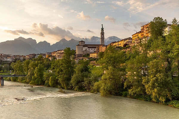 View of the historic center of Belluno with the Piave river flowing at sunset