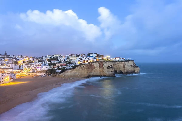 View of the lights of the village of Carvoeiro and its beach at blue hour