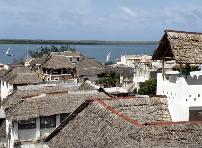 Framed Print : A view over makuti thatched roofs to the estuary that Framed Print : A view over makuti thatched roofs to the estuary that