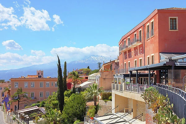 View of mount Etna and Metropole hotel from Piazza IX Aprile, Taormina, Sicily, Italy
