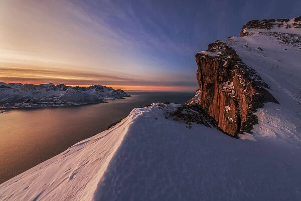 View from Mt. Hesten, above the fjord during a winter sunset, Senja island, Norway