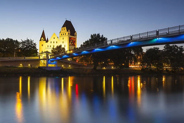 View across The River Danube towards New Palace iluminated at dusk, Ingolstadt, Upper