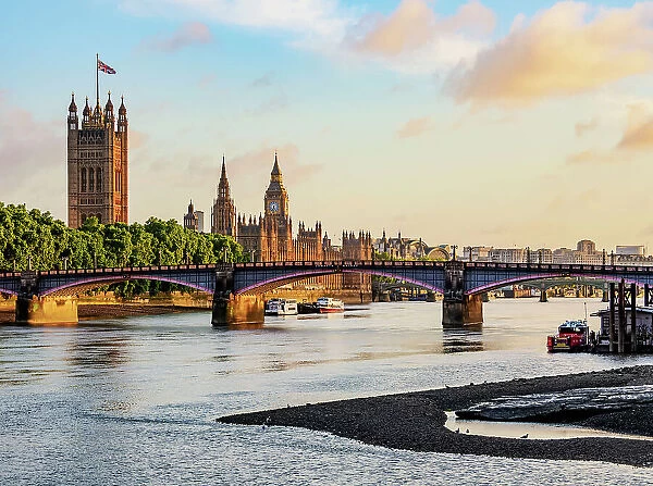 View over the River Thames towards the Palace of Westminster at sunrise, London, England, United Kingdom