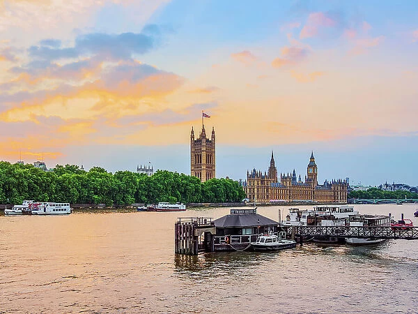 View over the River Thames towards the Palace of Westminster at sunset, London, England, United Kingdom
