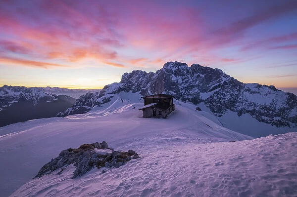 View of the snow-covered north face of the Presolana mountain in winter at sunrise with