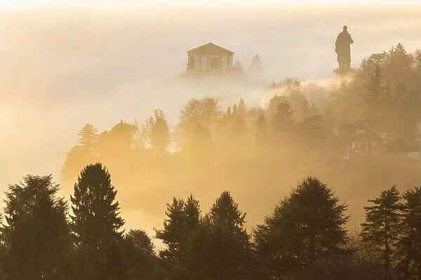 View of the Statue of San Carlo Borromeo in the morning winter fogs