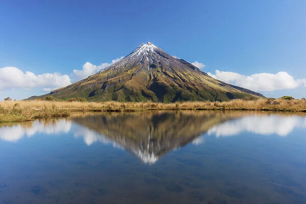 View of the Taranaki volcano in New Zealand northern island reflecting in a mountain pond