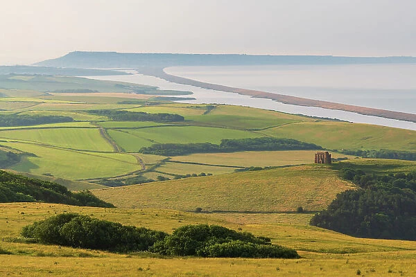 View over West Dorset's rolling countryside to St Catherine's Chapel and Chesil Beach, Dorset, England