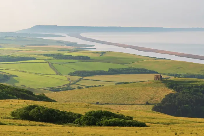 Framed Print : View over West Dorset's rolling countryside to St Catherine's Chapel and Chesil Beach, Dorset, England Framed Print : View over West Dorset's rolling countryside to St Catherine's Chapel and Chesil Beach, Dorset, England