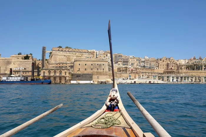 Framed Print : Views from a traditional water taxi towards Valletta with a Popeye Mascot, Valletta, Malta Framed Print : Views from a traditional water taxi towards Valletta with a Popeye Mascot, Valletta, Malta