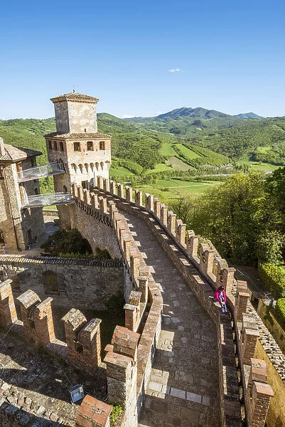 Vigoleno, Piacenza, Emiglia-Romagna, Italy. Woman sitting on the castle walls