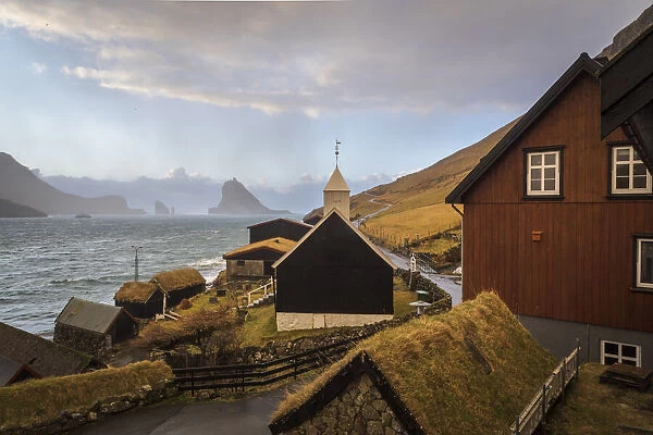 The village of Bour. In the background Drangarnir and Tindholmur. Vagar, Faroe Islands