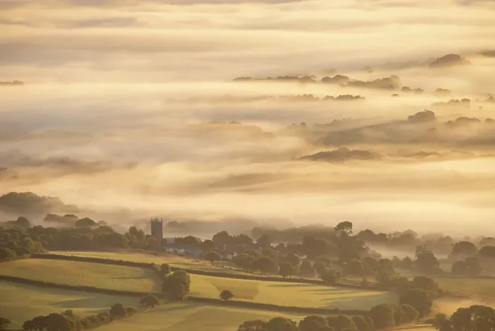 Framed Print : The village and church of South Tawton on a misty summer morning, Dartmoor National Park, Devon, England. Summer (August) 2024 Framed Print : The village and church of South Tawton on a misty summer morning, Dartmoor National Park, Devon, England. Summer (August) 2024
